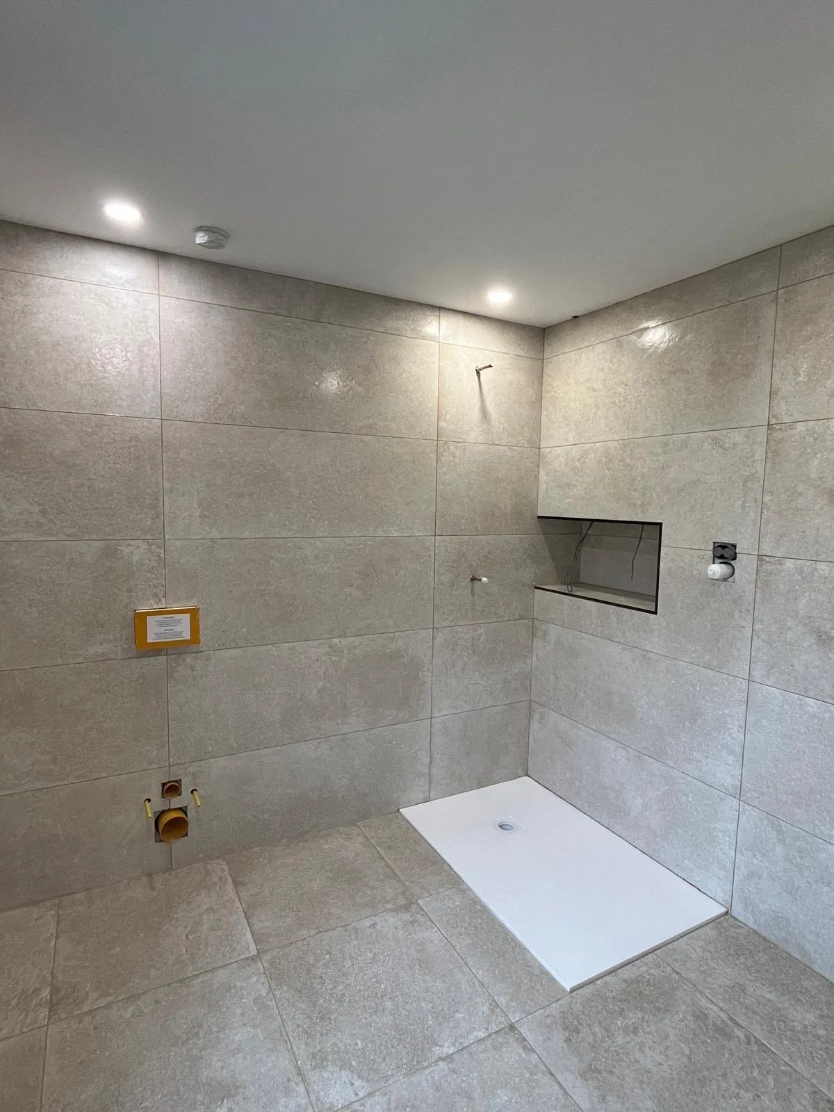 Grey large-format tiled shower room