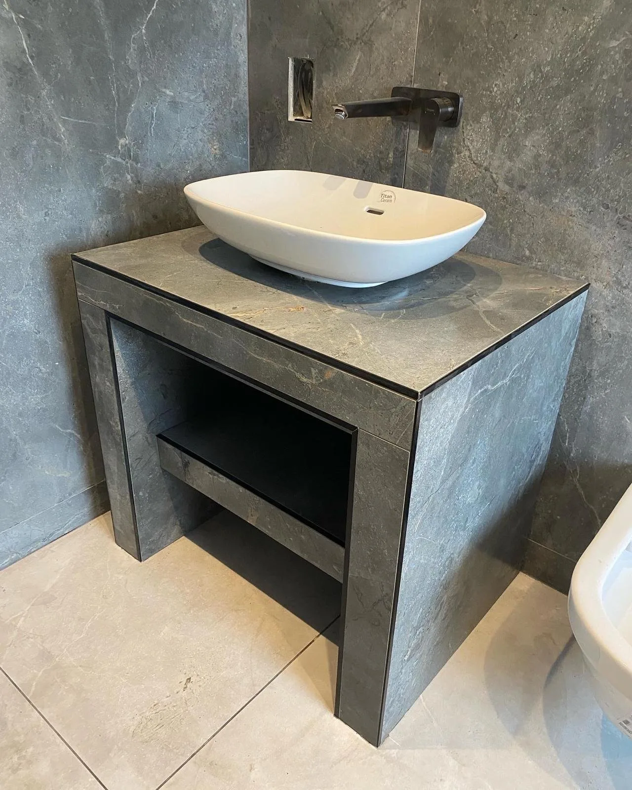Bespoke made-to-measure vanity unit built from mitred porcelain slabs