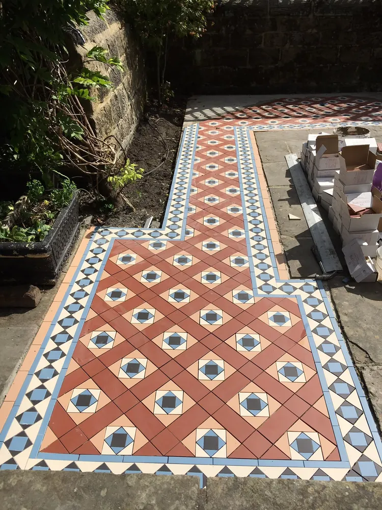 Traditional red, blue and buff Victorian tiled path with a diamond border